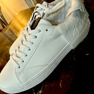 Brand new white casual sneakers with tags. Lace-up fastening.